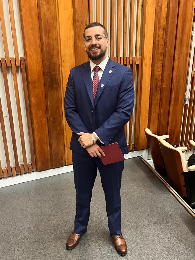 Daniel Felipe Montenegro in a navy suit, smiling at the camera