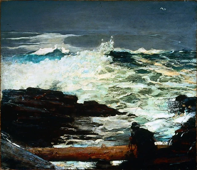 A lone figure in dark oilskins on wet rocks beside a breaking wave