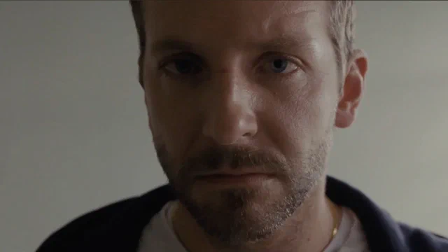 Pat in close-up, looking straight down the lens, in the scene the film opens with